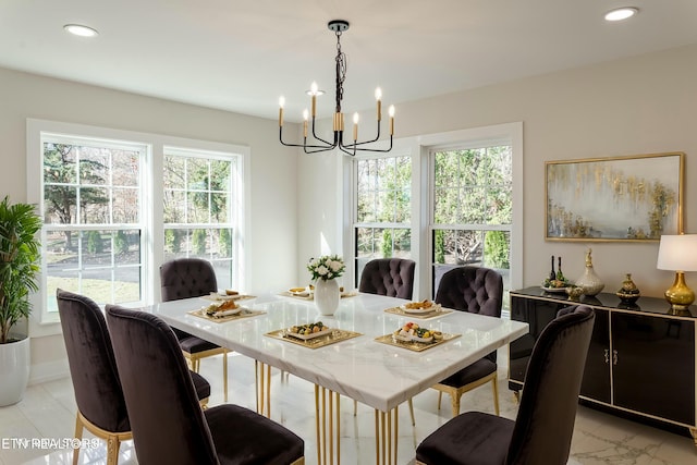 dining space with a healthy amount of sunlight and a notable chandelier