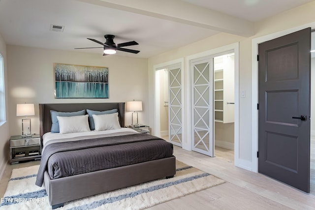 bedroom with light hardwood / wood-style floors and ceiling fan