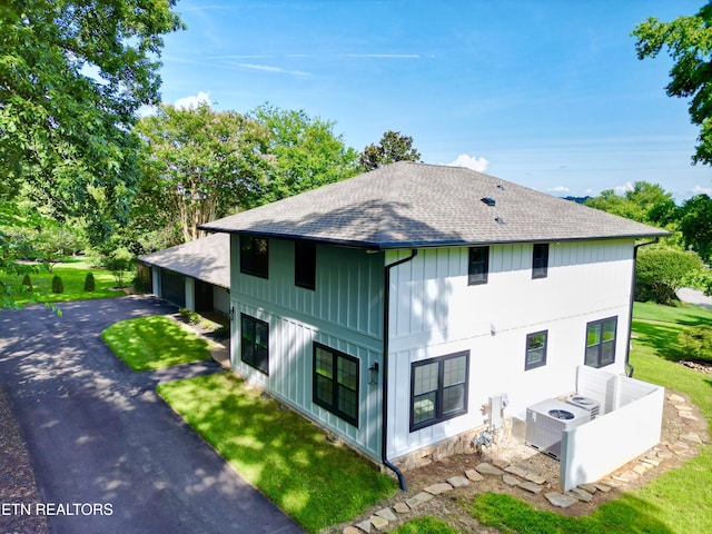 12000 S Fox Den Dr, Knoxville, TN 37934 - back of house featuring roof with shingles, a garage, and a lawn