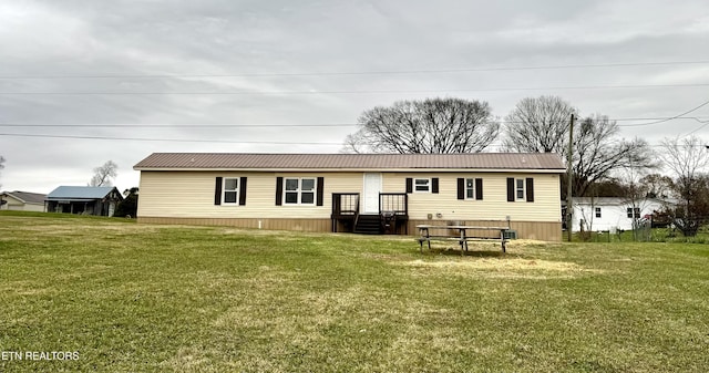 rear view of house with a lawn