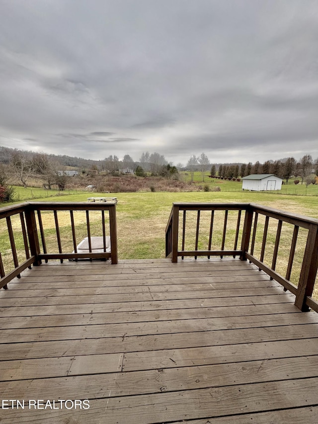 wooden terrace with a lawn