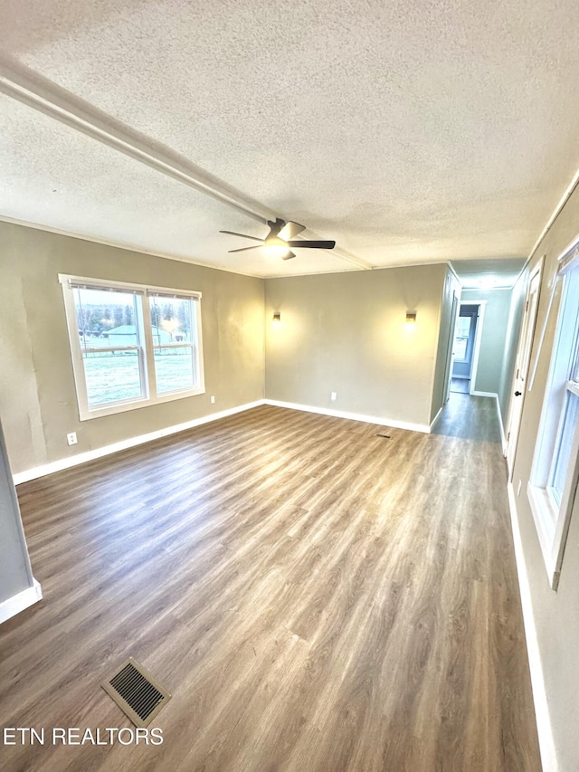 spare room featuring ceiling fan, hardwood / wood-style floors, and a textured ceiling