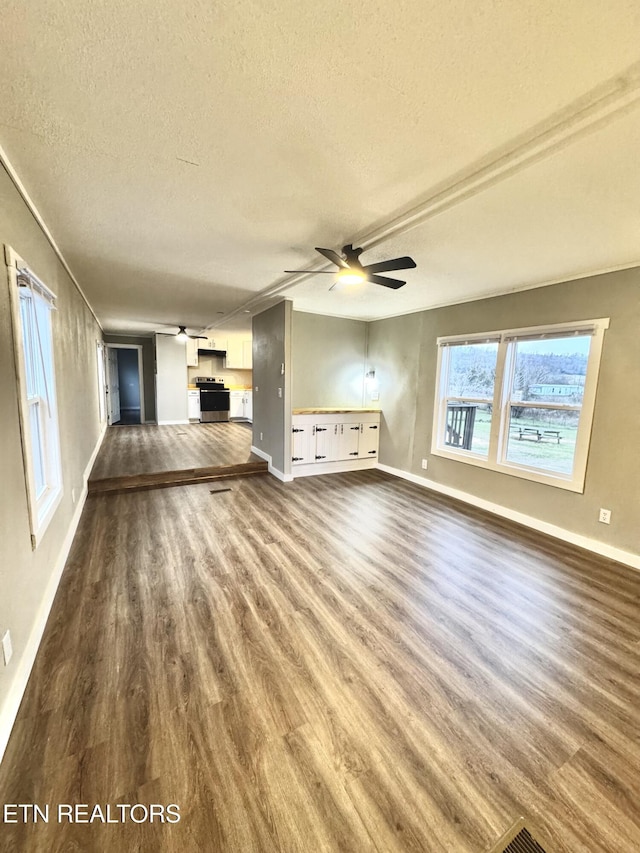 unfurnished living room with hardwood / wood-style flooring, ceiling fan, and a textured ceiling