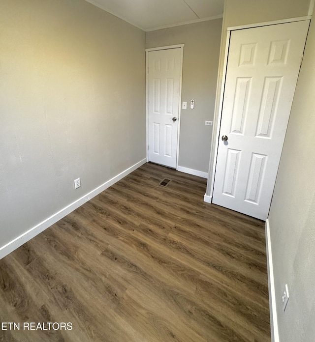 unfurnished room with dark hardwood / wood-style flooring