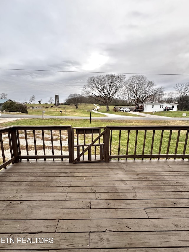 wooden deck featuring a yard