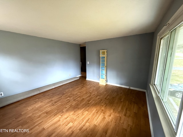 unfurnished room with hardwood / wood-style floors