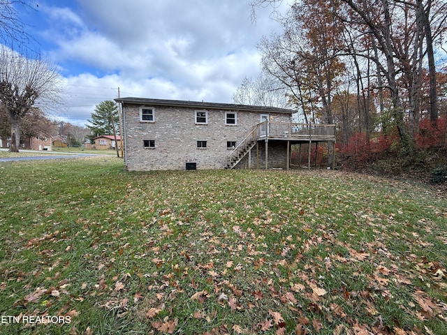 back of property featuring a yard and a wooden deck