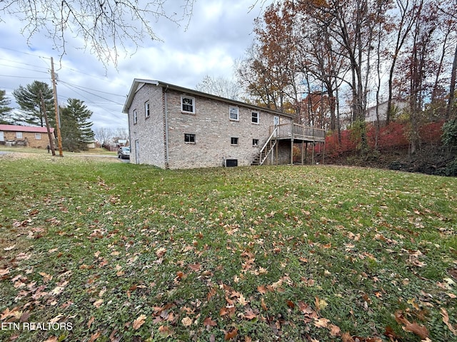 back of property with a lawn and a wooden deck