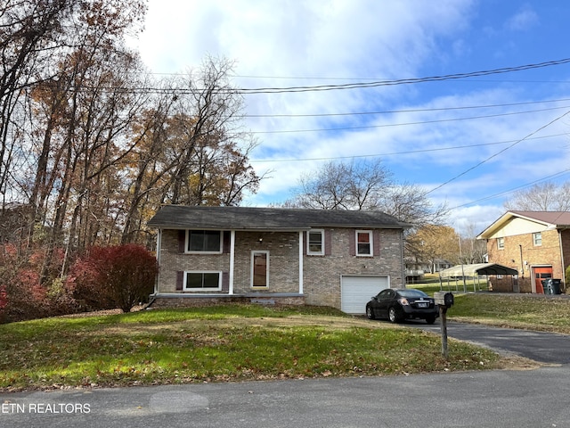 raised ranch with a garage and a front lawn