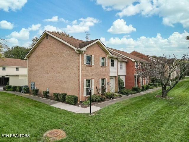 view of side of property with a lawn