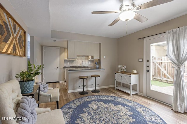 living room featuring light hardwood / wood-style floors and ceiling fan