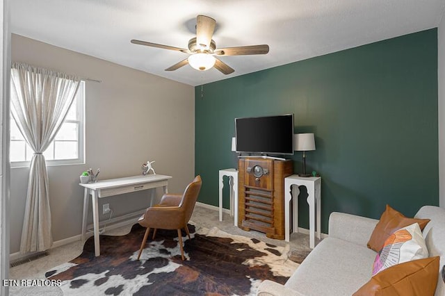 carpeted office space featuring ceiling fan