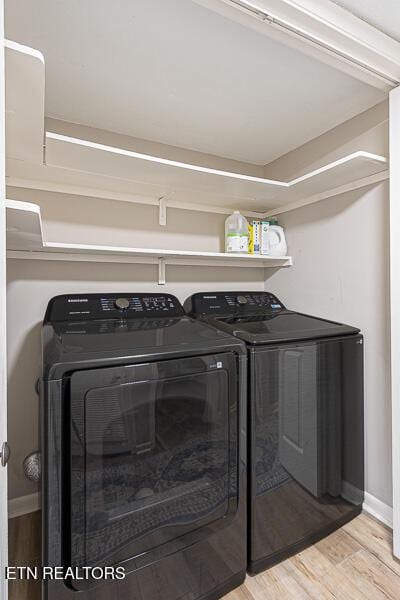 washroom with independent washer and dryer and light hardwood / wood-style floors