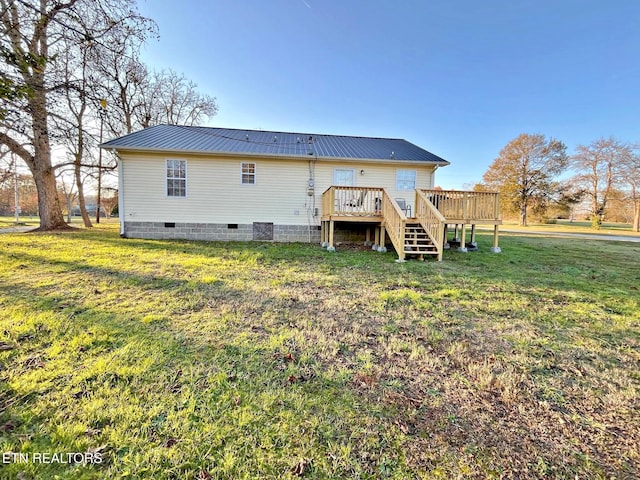 back of house with a deck and a lawn