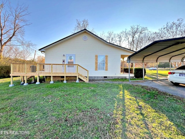 view of side of home featuring a carport, a deck, and a yard