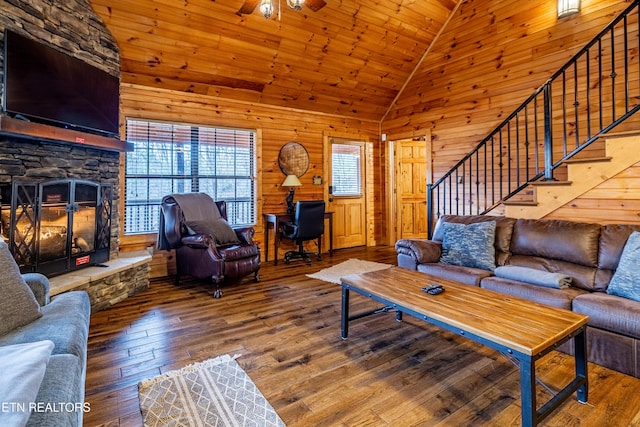 living room featuring wooden ceiling, high vaulted ceiling, a stone fireplace, wooden walls, and hardwood / wood-style flooring