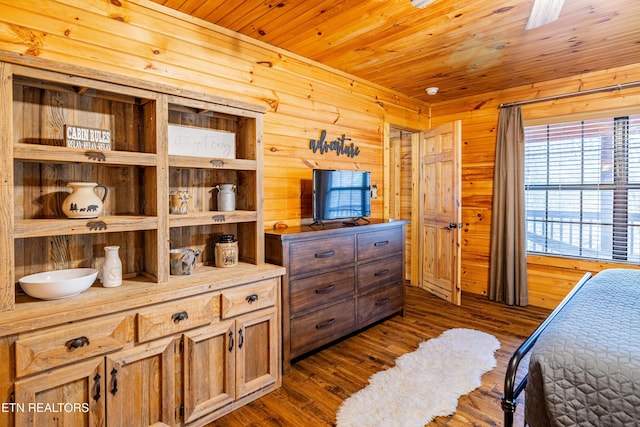 bedroom featuring wooden ceiling, wooden walls, and dark wood-type flooring