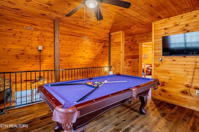 recreation room with hardwood / wood-style floors, ceiling fan, wood walls, and pool table