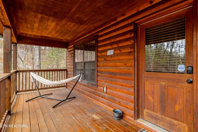 wooden terrace featuring covered porch