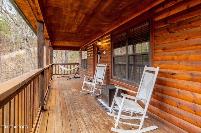 wooden terrace featuring covered porch