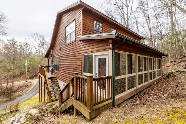 view of property exterior featuring a sunroom