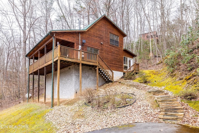 back of house with a wooden deck