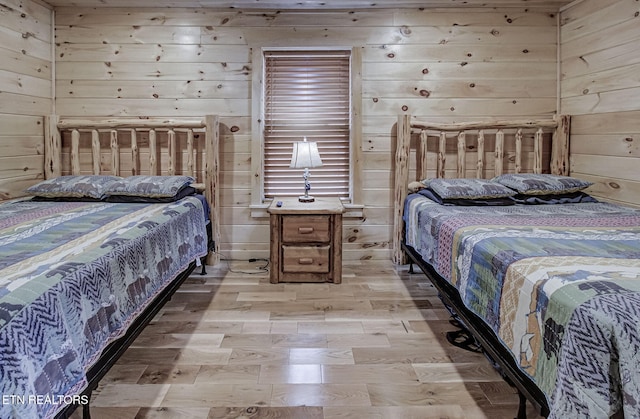 bedroom featuring wood walls