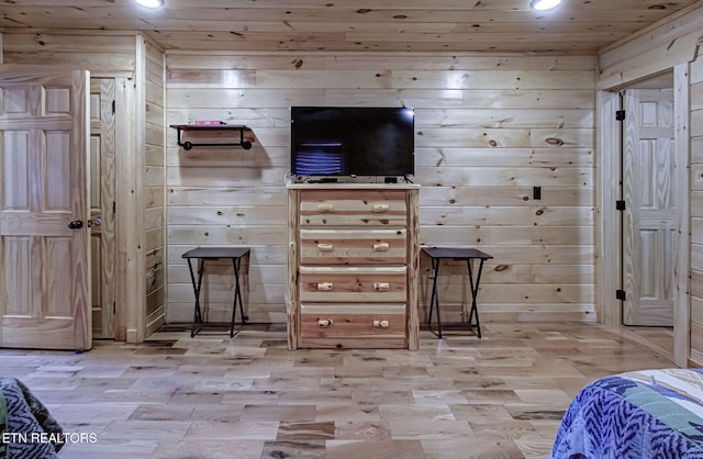 bar featuring light hardwood / wood-style floors, wooden ceiling, and wood walls