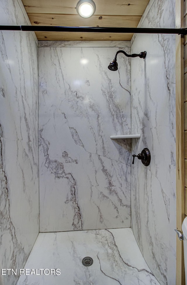 bathroom featuring wooden ceiling and a tile shower