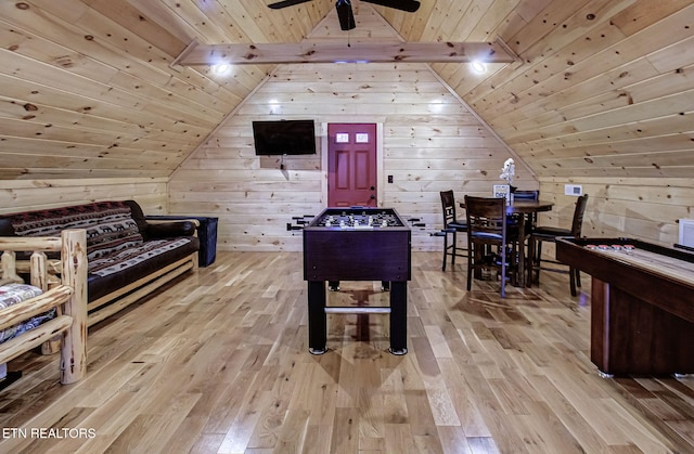 playroom with vaulted ceiling with beams, wood ceiling, light hardwood / wood-style floors, and wood walls