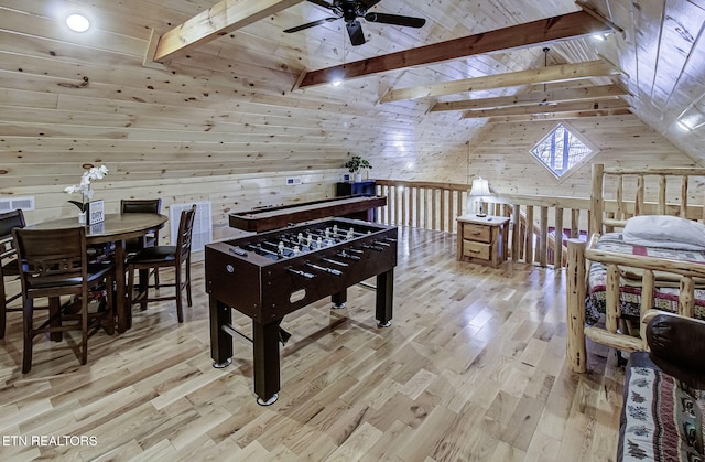 playroom featuring wood walls, ceiling fan, wooden ceiling, light wood-type flooring, and vaulted ceiling with beams