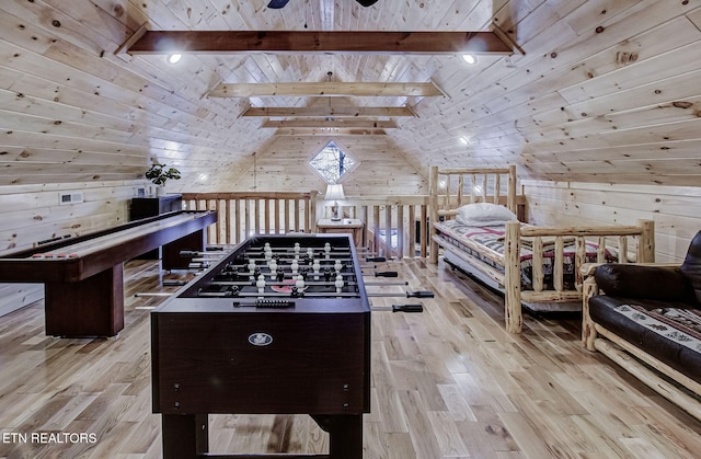 rec room featuring vaulted ceiling with beams, wood ceiling, wooden walls, and light hardwood / wood-style flooring