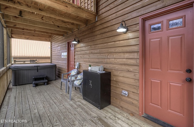 wooden terrace featuring a hot tub