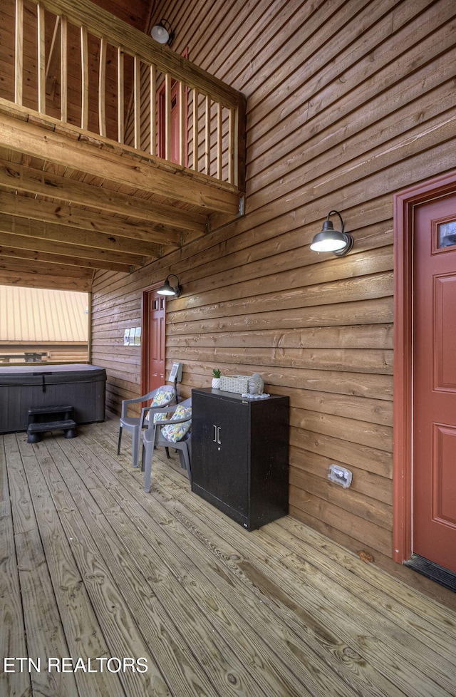 wooden deck featuring a hot tub