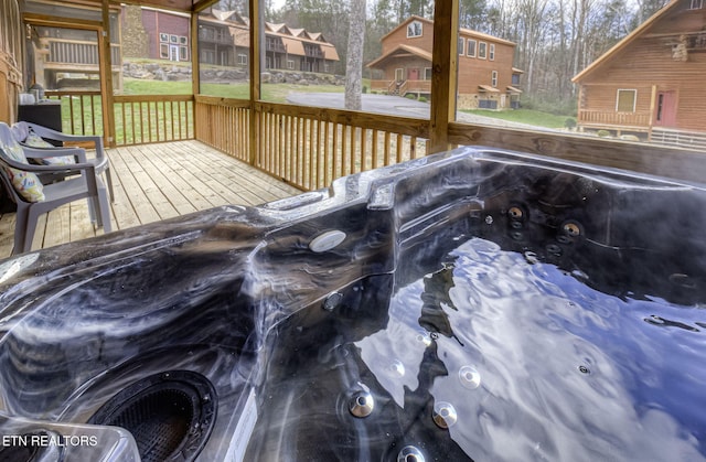 wooden terrace featuring a hot tub