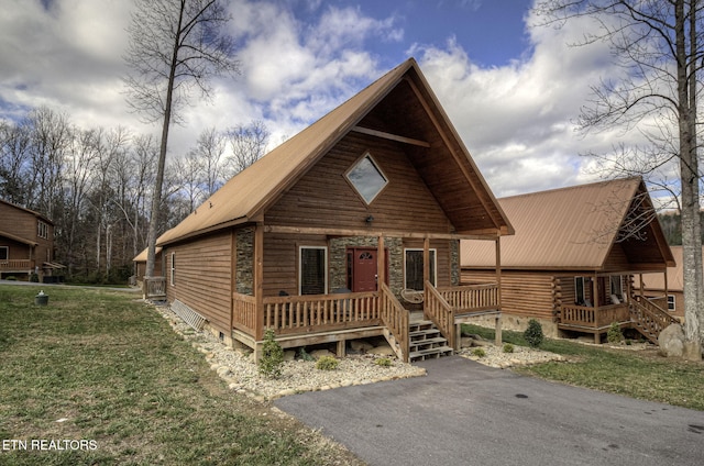 log cabin featuring a front lawn