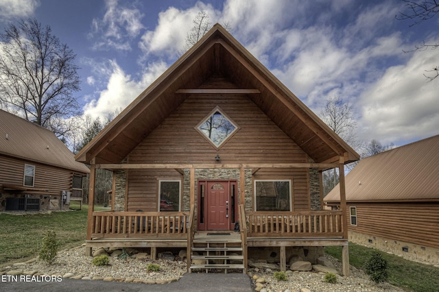 log cabin featuring central AC unit and covered porch