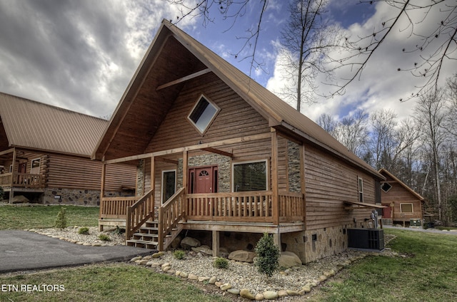 log home featuring cooling unit and a front lawn