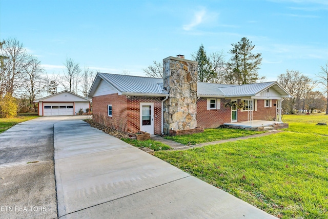 single story home with a front yard, an outbuilding, and a garage