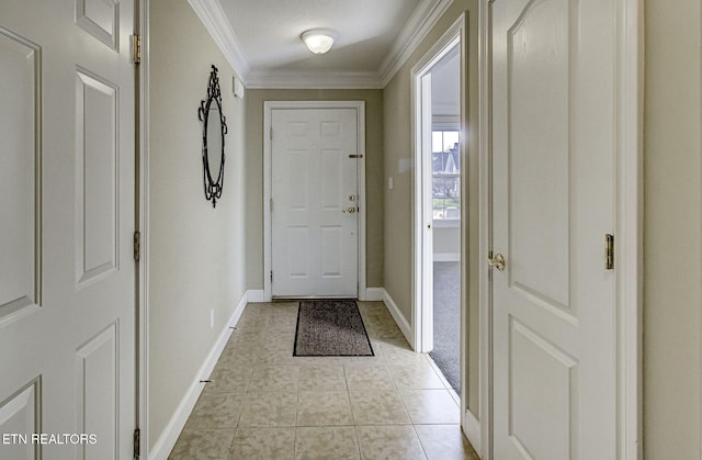 doorway to outside with light tile patterned floors, a textured ceiling, and ornamental molding