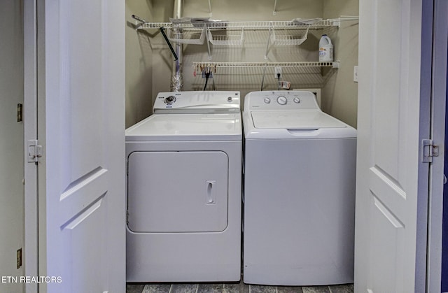 clothes washing area featuring light tile patterned flooring and washing machine and clothes dryer