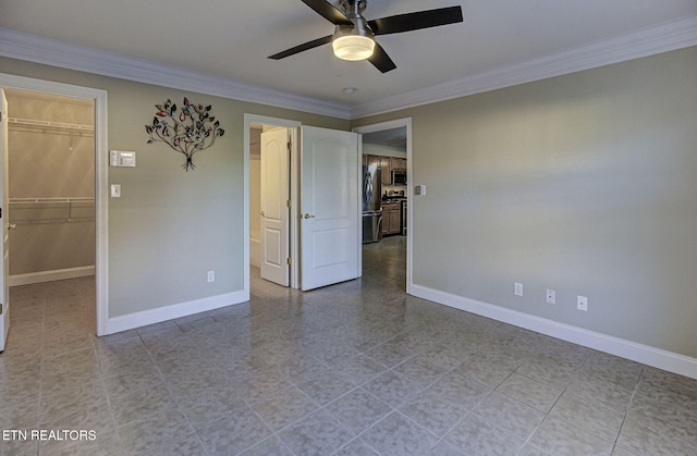 unfurnished bedroom with ceiling fan, a spacious closet, ornamental molding, stainless steel refrigerator, and a closet