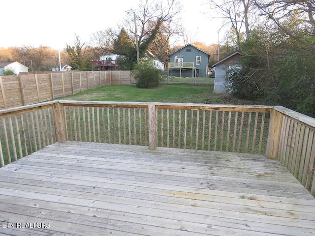 wooden terrace featuring a yard