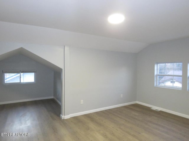 bonus room featuring hardwood / wood-style flooring and vaulted ceiling