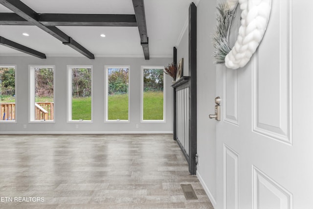 unfurnished sunroom with beam ceiling