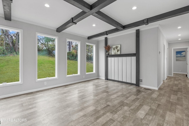 interior space with beam ceiling, light hardwood / wood-style flooring, and ornamental molding