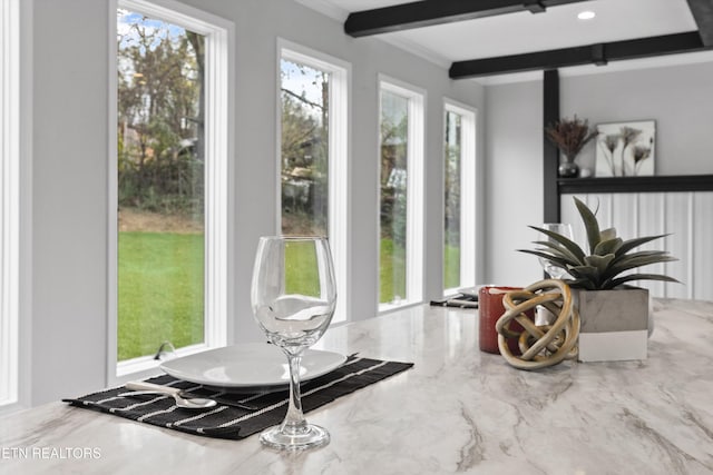 sunroom / solarium with beam ceiling and a healthy amount of sunlight