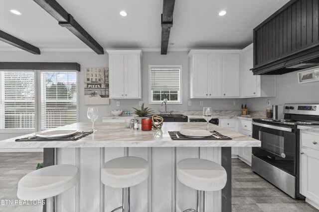 kitchen featuring beam ceiling, a center island, stainless steel range with electric cooktop, and ventilation hood