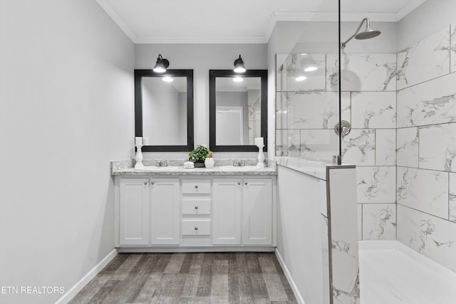 bathroom featuring hardwood / wood-style flooring, vanity, a tile shower, and ornamental molding