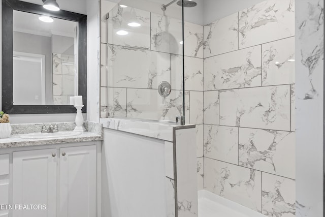 bathroom with vanity and tiled shower